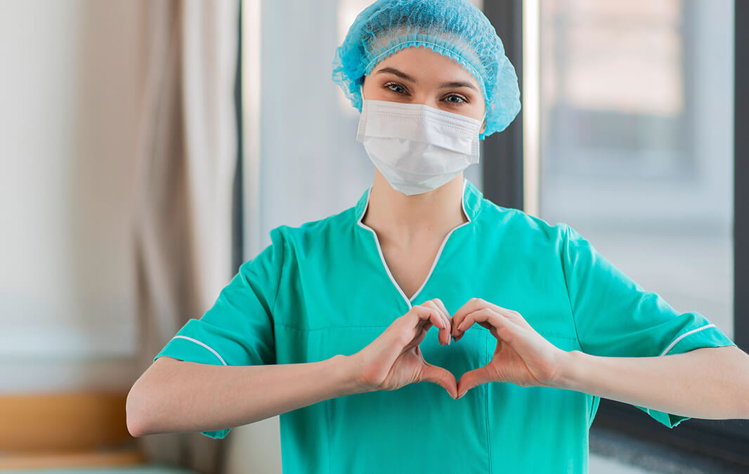 Nurse doing heart shape sign